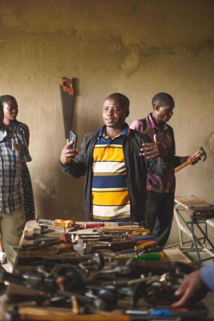 Adults taking part in a hands-on workshop in Kasese