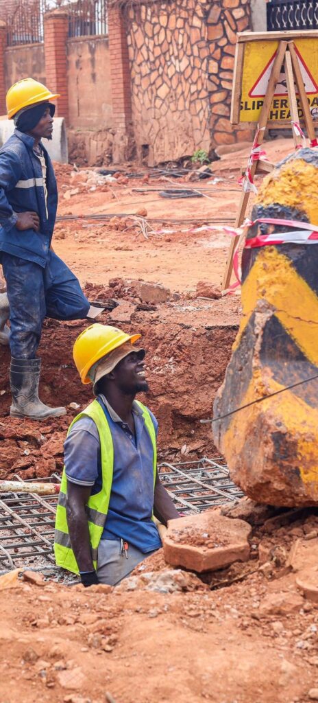 Construction workers laying pipes on a site in Kampala