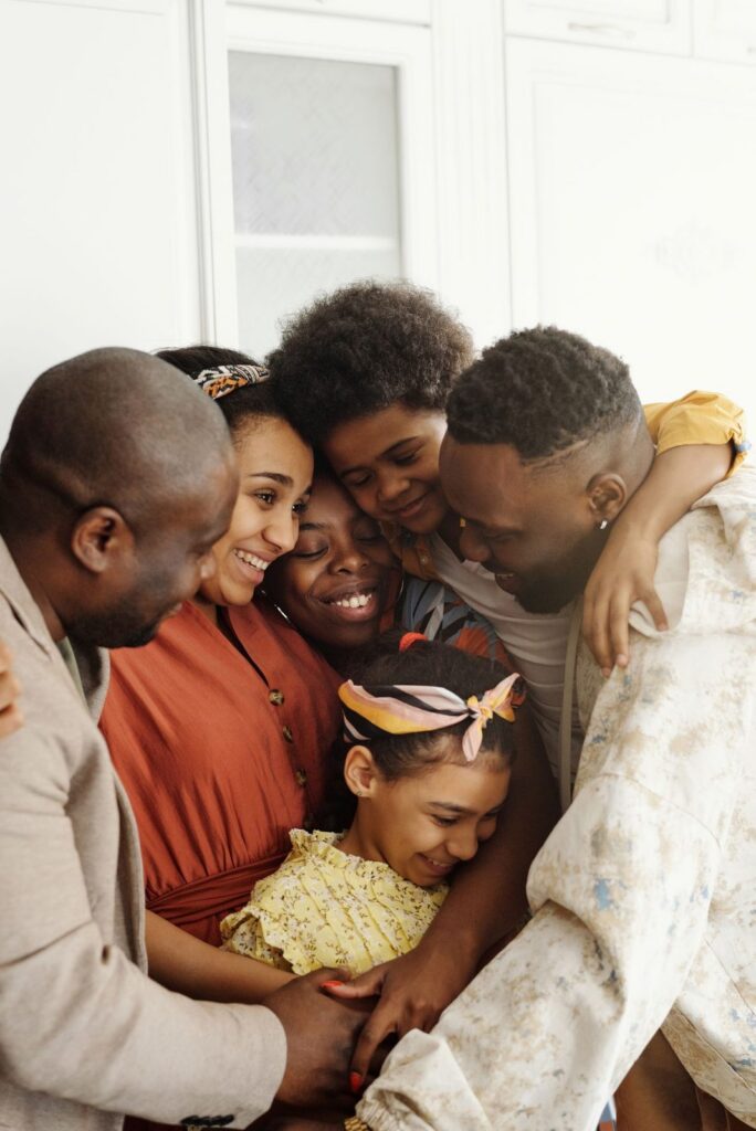 Family sharing a warm embrace at home