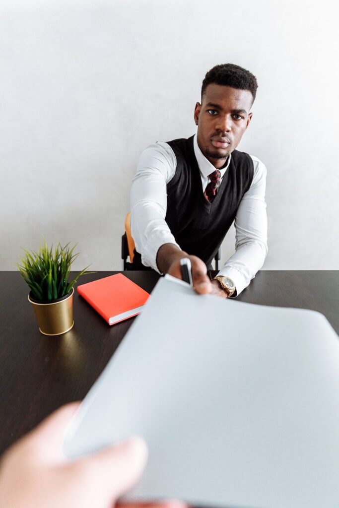 Banker handing a document across the desk