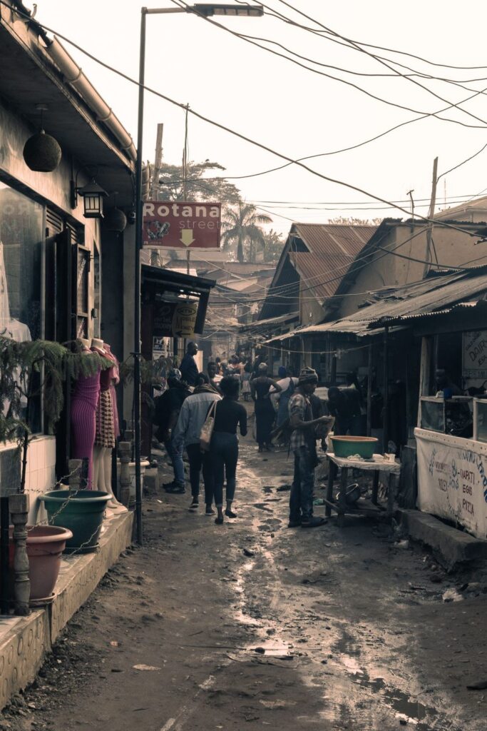 Shoppers in a narrow street market in Kampala