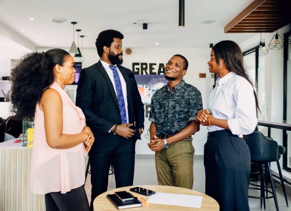 Colleagues talking in a bright open-plan office