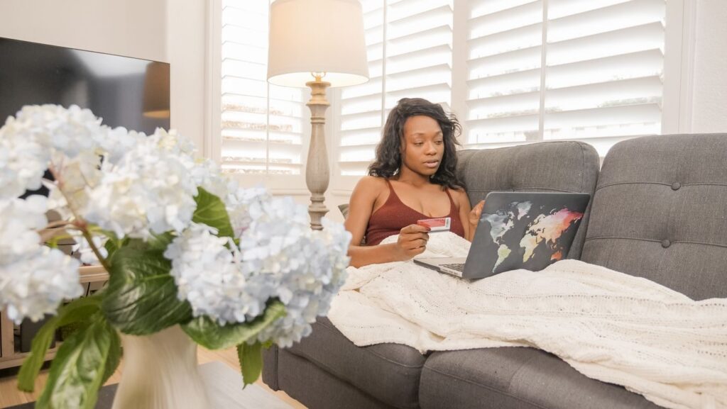 Woman paying online with a card and a laptop