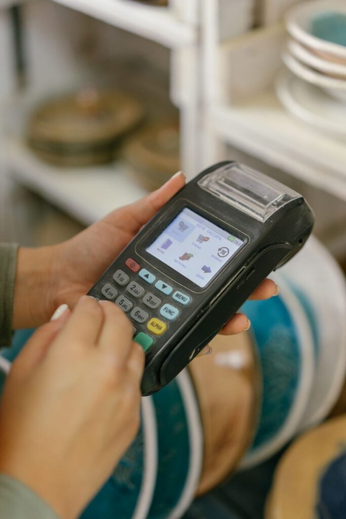 Shop assistant holding a card payment machine