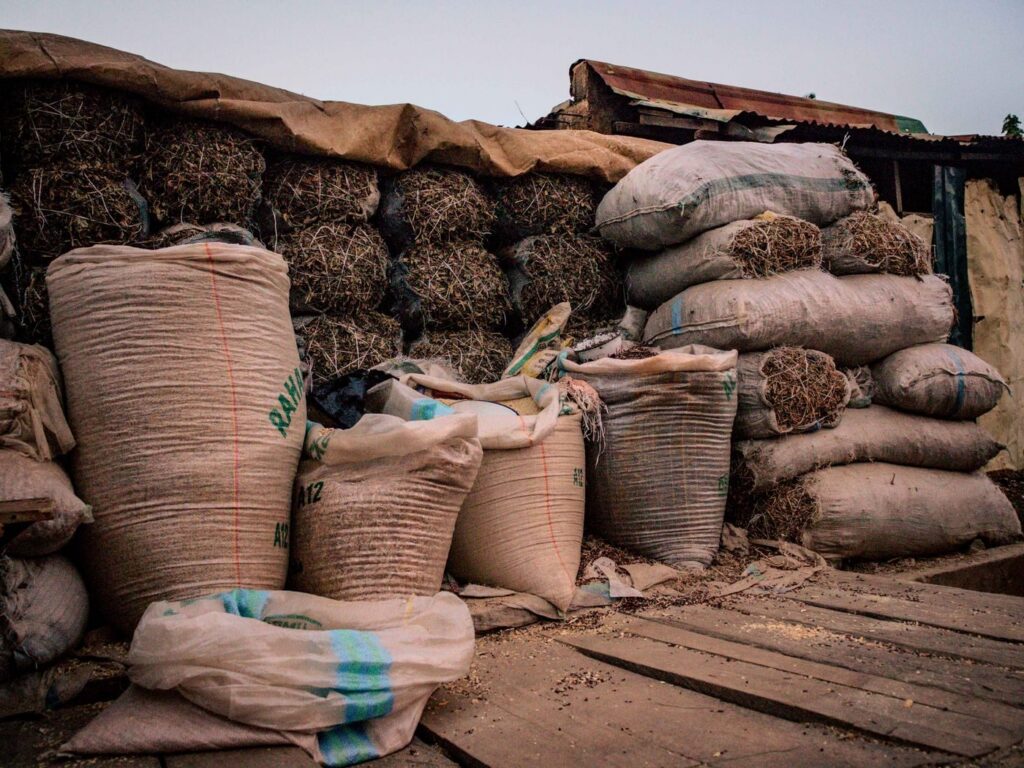 Sacks of produce stacked at a market