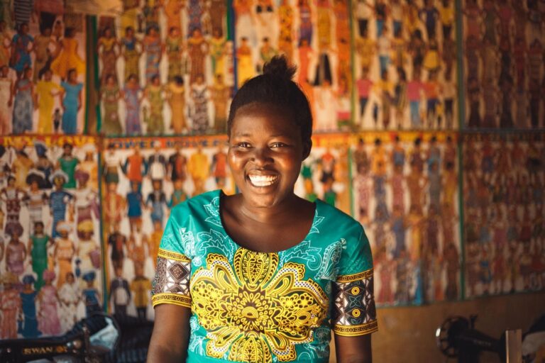 Smiling woman in a patterned dress in Gulu