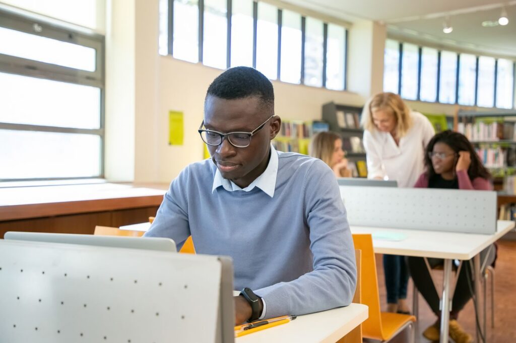 Student working on a laptop in a university library